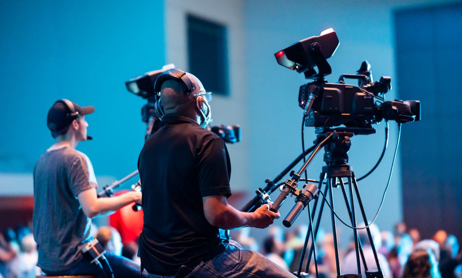 Panel interview and community discussion room configured for multi-speaker broadcast