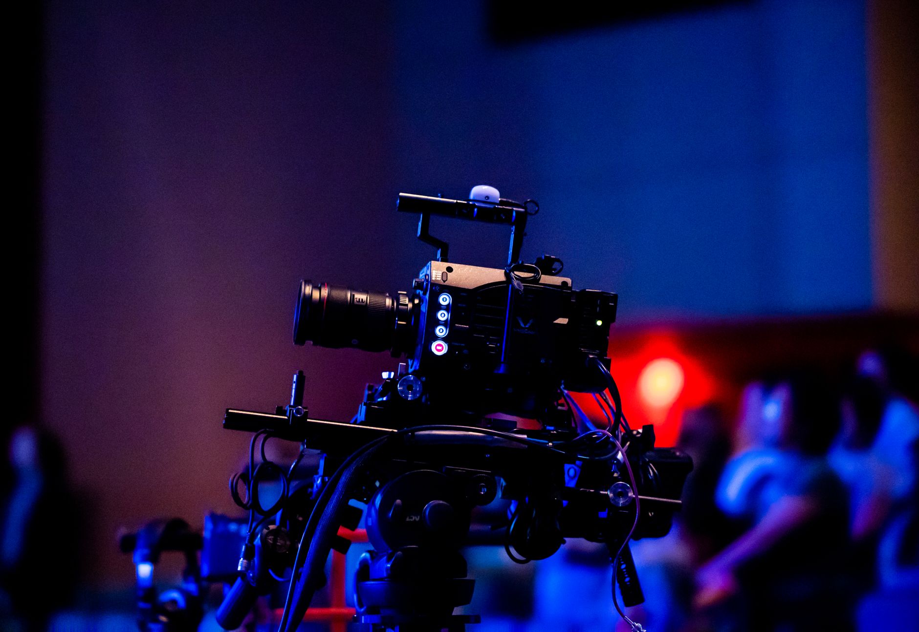 Broadcasting studio workspace with video camera, studio monitor, and vocal microphone setup